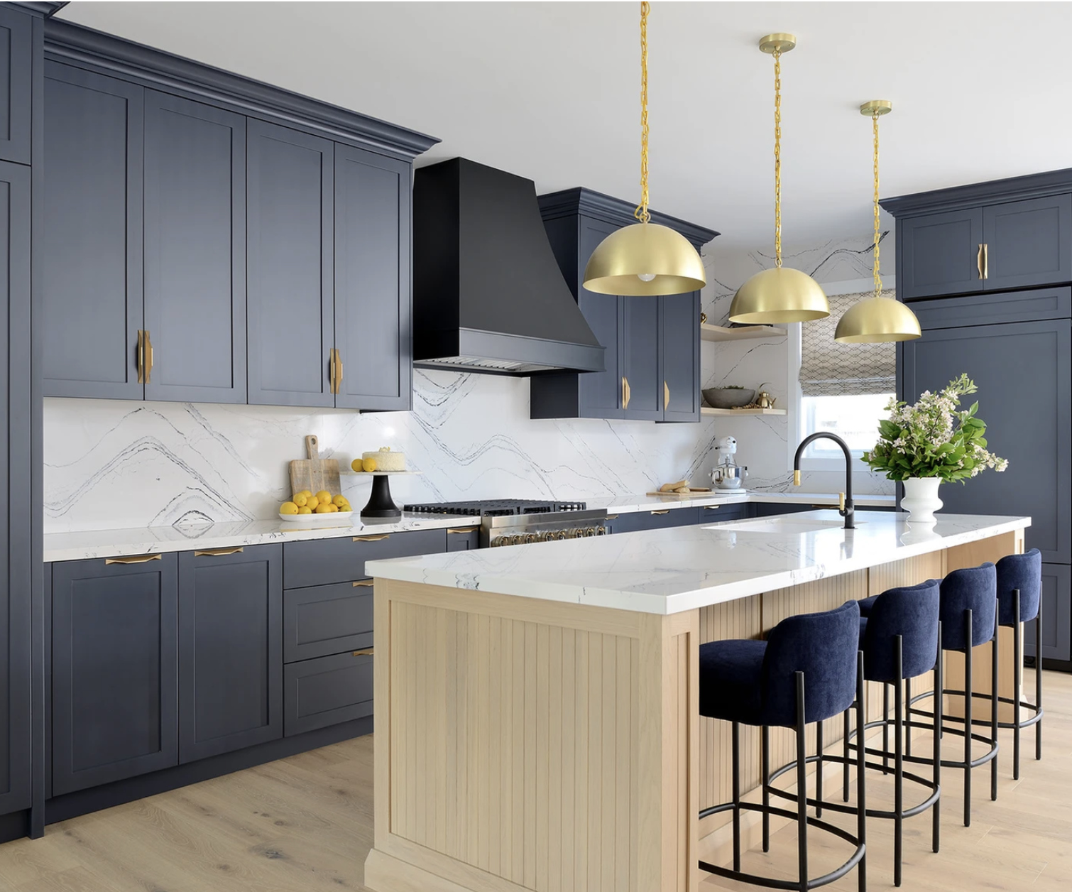 Modern kitchen with navy cabinets and gold accents